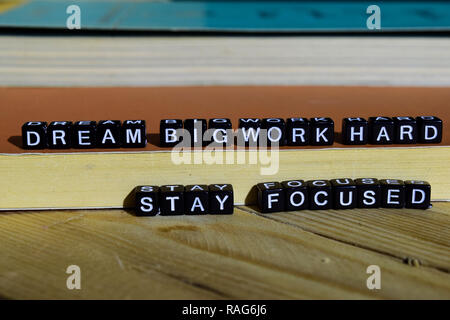 Dream big work hard stay focused on wooden blocks. Motivation and inspiration concept. Cross processed image Stock Photo