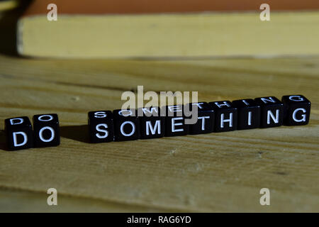 Do something on wooden blocks. Motivation and inspiration concept. Cross processed image Stock Photo