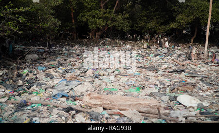 Garbage environmental pollution in mangrove ecological problem in asia. garbage, trash on shore in mangroves, all kinds, plastic bottles, styrofoam, rubber, aluminum and glass cans, java, indonesia.Garbage pollution Stock Photo