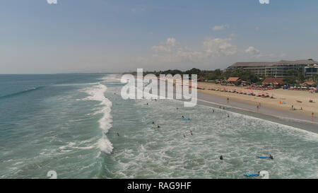 Aerial view sand beach with surfers and tourists, Kuta, Bali. surfers on water surface ocean catch wave. Seascape, beach, ocean, sky sea Travel concept Stock Photo