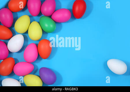 Multi colored easter eggs against a bright blue background. Stock Photo