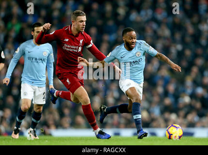 Liverpool's Jordan Henderson (left) and Manchester City's Raheem Sterling (right) during the Premier League match at the Etihad Stadium, Manchester. Stock Photo