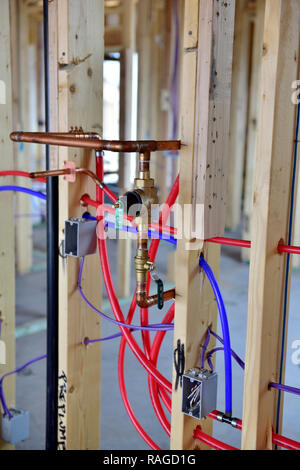 https://l450v.alamy.com/450v/ragd1g/house-construction-in-usa-instillation-of-water-pipes-and-electrical-wiring-in-timber-framework-of-domestic-home-ragd1g.jpg