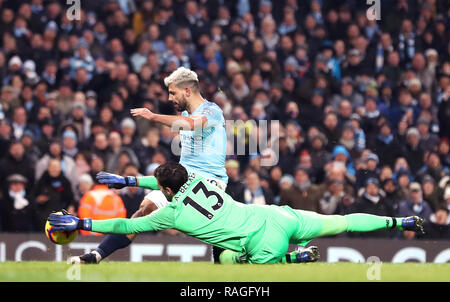 Manchester City's Sergio Aguero has a shot saved by Liverpool goalkeeper Alisson Becker (left) during the Premier League match at the Etihad Stadium, Manchester. Stock Photo