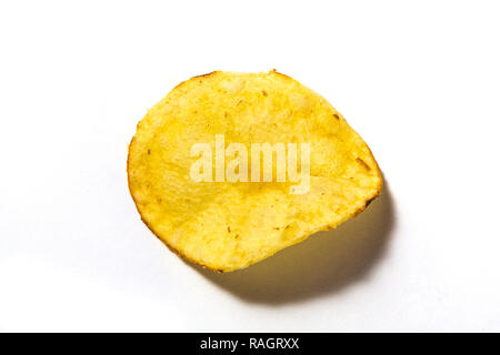 Single potato crisp on a white background. Stock Photo