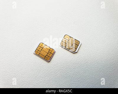 two micro sim cards on a light background surface Stock Photo