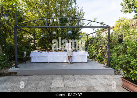 Woman takes food at the party during a wedding day Stock Photo