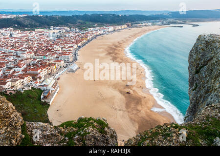 Nazaré beach seen from above, from the Sítio's viewpoint, with rocks in foreground. Stock Photo