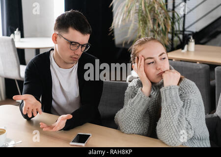 Annoyed man trying to explain something to his wife Stock Photo