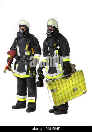 Firefighters, response squad for fire fighting, wearing protective clothing made of Nomex, a helmet with a visor, a fire axe, Stock Photo