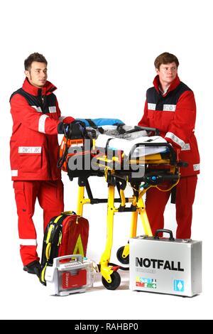 Paramedics with emergency equipment, first aid kit with bandages, medication, a defibrillator, ECG, breathing apparatus and a Stock Photo