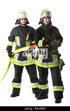 Firemen, part of a response squad for firefighting, with protective clothing made of Nomex, a helmet with a visor, a fire axe, Stock Photo