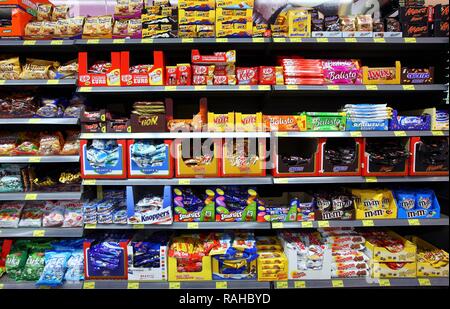 Shelves with various candies, chocolate bars, self-service, food department, supermarket Stock Photo