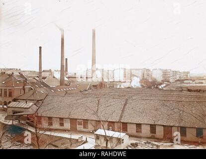 Exterior of factory buildings with chimneys, in the foreground wooden barrels, Anonymous, c. 1900 - c. 1910 reimagined Stock Photo