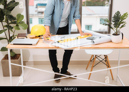 Workplace items tools for project, Architect or Engineer working on blueprint for architectural project in progress, construction and structure concep Stock Photo