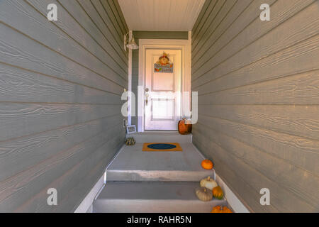 White front door with pumpkins and steps Stock Photo