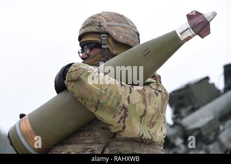 U.S. Paratroopers assigned to the 4th Battalion, 319th Airborne Field Artillery Regiment, fire precision guided munitions from M777 Howitzers while conducting Artillery Gunnery Table XVIII at the 7th Army Training Command’s Grafenwoehr Training Area, Germany, Feb. 3, 2017. The Exercise trains and evaluates the Battalion's ability to mass fires in direct support of the 173rd Airborne Brigade.  Evaluators from the 82nd DIVARTY, assist the battalion by objectively reviewing its timeliness and accuracy of massed fires while firing in support of a heavy weapons company defensive live fire exercise. Stock Photo