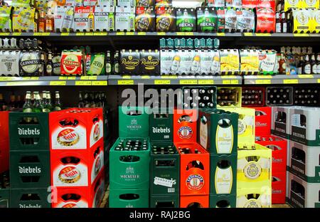 Shelves with different types of beer in six packs and boxes, self-service, food department, supermarket Stock Photo