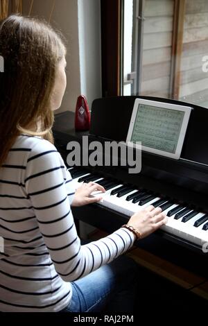 young girl playing an electronic piano keyboard Stock ...