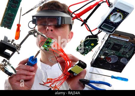 Electronics, electrical engineering, computer engineering, electronics technician soldering an electronic board Stock Photo