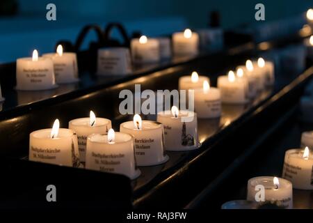 Burning candles in a church, Saint Nicholas parish church, Parrocchia San Nicolò, Merano, Trentino, South Tyrol, Italy Stock Photo