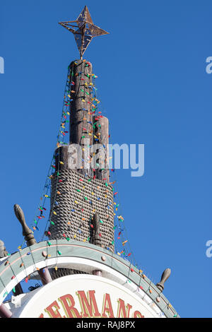 Christmas decorations on the ship wheel sign in Fisherman's Wharf in San Francisco, California at Pier 39 Stock Photo