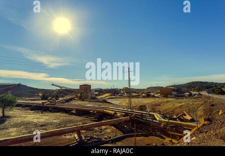 Complex of mine buildings of a old mining enterprise in Riotinto with mineral conveyor belt and and pipes for the extraction of gold and cooper, with  Stock Photo