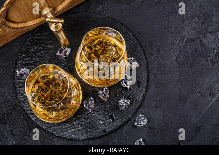 Two glasses of Cognac with ice cubes Stock Photo