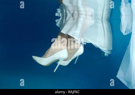 Bride's feet, underwater wedding in pool, Odessa, Ukraine, Eastern Europe Stock Photo