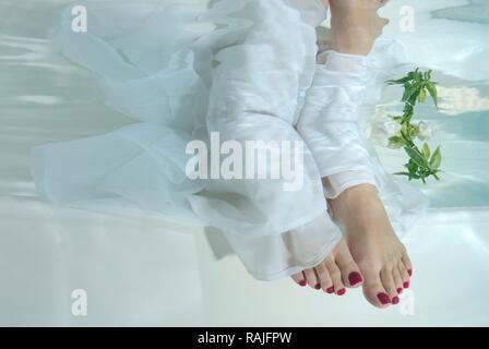 Bride's feet, underwater wedding in pool, Odessa, Ukraine, Eastern Europe Stock Photo