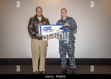 SILVERDALE Wash. (Feb. 08, 2017) – Rear Adm. Gary Mayes, commander, Navy Region Northwest (left), presents a pennant to Capt. Alan Schrader, commanding officer, Naval Base Kitsap (NBK), for winning the 2017 Installation Excellence Award. NBK beat out 71 other installations worldwide, to win the Installation Excellence Award from Commander, Navy Installations Command along with more than $200,000 to spend on command beautification. Stock Photo