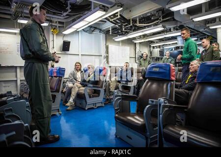 PACIFIC OCEAN (Feb. 10, 2017) Former Secretary of the Navy John Lehman and distinguished visitors are briefed by the pilots assigned to the Vikings of Electronic Attack Squadron (VAQ) 129 in a ready room aboard the aircraft carrier USS Theodore Roosevelt (CVN 71). Theodore Roosevelt is currently off the coast of Southern California conducting routine training operations. Stock Photo