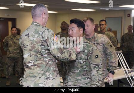 Torii Station, Okinawa (Feb 12, 2017) – Maj. Gen. James Pasquarette awards Sgt. Andrew Lee an Army commendation medal for being the top NCO finisher in US Army Japans best warrior competition in Okinawa. The top competitors of this competition will continue on to compete in a pacific-wide competition in Hawaii. Stock Photo