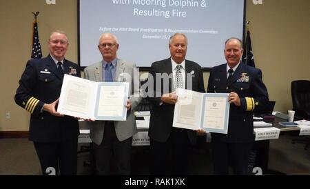 Capt. Peter Martin, commander, Sector Houston-Galveston, and Rear Adm. David Callahan, commander, 8th Coast Guard District, present the Coast Guard Meritorious Service Award to Houston Pilots Captains Michael McGee and Michael Phillips, Feb. 10, 2017. They received the award for their outstanding response to the Aframax River tanker fire in the Houston Ship Channel, Sept. 2016. Stock Photo