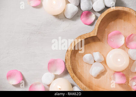 Spa settings with roses. Spa theme with candles and flowers on table. Stock Photo