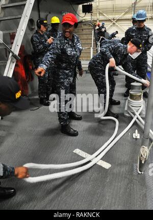 GREAT LAKES, Ill. (Feb. 21, 2017) Boatswain's Mate 2nd Class Demour Christian, Junior Instructor of the Year, trains recruits from Division 099 on proper line handling techniques at the USS Marlinespike lab at Recruit Training Command. Recruits participate in the lab in preparation for battle stations. About 30,000-40,000 recruits graduate annually from the Navy's only boot camp. Stock Photo