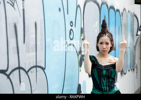 Asian female model poses for pictures on the street Stock Photo