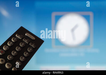 Smart television screen with close up tv remote control in foreground Stock Photo