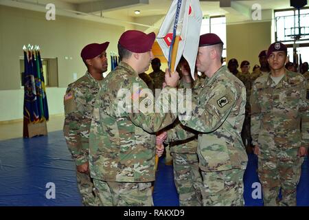 Capt. Shane R. Covert, right, passes the Echo Company guidon to Lt. Col. Benjamin A. Bennett, center, commander of 54th Brigade Engineer Battalion, 173rd Airborne Brigade, Feb. 15, 2017, during the change of command ceremony for Echo Company, 54th Brigade Engineer Battalion at Caserma Del Din in Vicenza, Italy. The 173rd Airborne Brigade based in Vicenza, Italy, is the Army Contingency Response Force in Europe, and is capable of projecting forces to conduct the full of range of military operations across the United State European, Central and Africa Commands areas of responsibility. Stock Photo