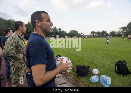 PUERTO BARRIOS, Guatemala (Feb. 11, 2017) - Hospital Corpsman 2nd Class Omar MurielMedina, a native of Orlando, Fla., assigned to Naval Hospital Jacksonville, Fla., watches U.S. and Guatemalan service members play soccer in support of Continuing Promise 2017's (CP-17) visit to Puerto Barrios, Guatemala. CP-17 is a U.S. Southern Command-sponsored and U.S. Naval Forces Southern Command/U.S. 4th Fleet-conducted deployment to conduct civil-military operations including humanitarian assistance, training engagements, and medical, dental, and veterinary support in an effort to show U.S. support and c Stock Photo