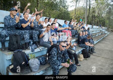 PUERTO BARRIOS, Guatemala (Feb. 11, 2017) - Sailors from various commands and host nation residents cheer on U.S. and Guatemalan service members during a soccer game played between the two in support of Continuing Promise 2017's (CP-17) visit to Puerto Barrios, Guatemala. CP-17 is a U.S. Southern Command-sponsored and U.S. Naval Forces Southern Command/U.S. 4th Fleet-conducted deployment to conduct civil-military operations including humanitarian assistance, training engagements, and medical, dental, and veterinary support in an effort to show U.S. support and commitment to Central and South A Stock Photo