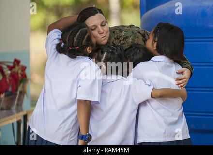 RAYONG PROVINCE, Thailand (Feb. 21, 2017) – Hospital Corpsman 1st Class Samantha Clark, assigned to 1 Marine Expeditionary Force Headquarters Group, bids farewell to Thai students during a dedication ceremony, marking the completion of the Ban Nong Muang school expansion project. The project was a joint effort by the U.S. Naval Mobile Construction Battalion 5, Construction and Developmental Regiment, Sattahip Naval Base and Korean Naval Mobile Construction Battalion 2nd Engineer, part of Cobra Gold 2017. Cobra Gold, in its 36th iteration, is the largest Theater Security Cooperation exercise in Stock Photo