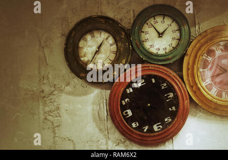 Abstract Retro Clocks on the Stone Wall Background Stock Photo