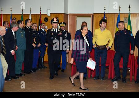 Mrs. Robin Smith (center), political advisor to the U.S. Army Africa Commanding General, Brig. Gen. Giovanni Pietro Barbano (left), Center of Excellence for Stability Police Units (CoESPU) director and U.S. Army Col. Darius S. Gallegos (rear), CoESPU deputy director arrive at the conference room for the graduation ceremony of the 14th Protection of Civilians Course at the CoESPU in Vicenza, Italy, February 21, 2017.