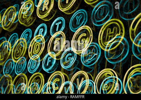Blue and green neon typewriter keys close up, selective focus Stock Photo