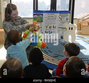 U.S. Air Force Capt. Christina Wengler, 633rd Dental Squadron dentist, demonstrates proper brushing techniques with children at the Langley Child Development Center at Joint Base Langley-Eustis, Va., Feb. 21, 2017. Dentists visited with all age groups at the CDCs to discuss oral hygiene techniques.