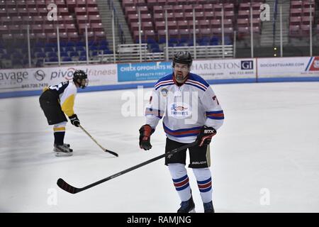 Members of the Charleston Patriots and the Charleston Enforcers play hockey during the 3rd Annual Matuskovic Charity Hockey Game at the North Charleston Coliseum & Performing Arts Center, Feb. 18, 2017. The game is played in memory of Joe Matuskovic, Charleston County Sherriff’s deputy, and other service members and first responders killed in the line of duty. Members of the Charleston Patriots are from Joint Base Charleston while members of the Charleston Enforcers are from the Charleston County Sheriff’s office and fire department.The Charleston Enforcers won the game with a final score of 1 Stock Photo