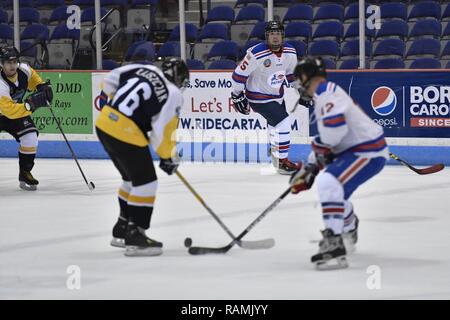 Members of the Charleston Patriots and the Charleston Enforcers play hockey during the 3rd Annual Matuskovic Charity Hockey Game at the North Charleston Coliseum & Performing Arts Center, Feb. 18, 2017. The game is played in memory of Joe Matuskovic, Charleston County Sherriff’s deputy, and other service members and first responders killed in the line of duty. Members of the Charleston Patriots are from Joint Base Charleston while members of the Charleston Enforcers are from the Charleston County Sheriff’s office and fire department.The Charleston Enforcers won the game with a final score of 1 Stock Photo