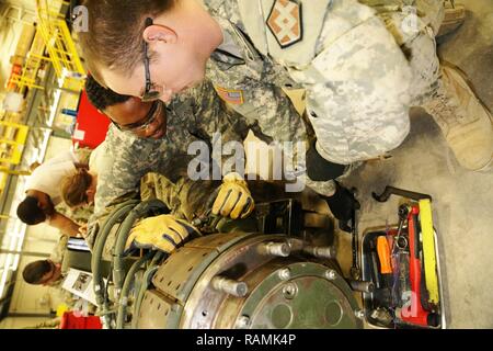 Spc. Christopher Norwood with the 275th Quartermaster Company at Fort Pickett, Va., and Sgt. Marquett Evans with the 422nd Civil Affairs Battalion at Greensboro, N.C., both students at Regional Training Site-Maintenance in the Wheeled Vehicle Mechanics Course, work on a project Feb. 10, 2017, at Fort McCoy. During the course, students learn to complete all basic concepts required to be certified as an Army wheeled-vehicle mechanic. This includes performing field-level maintenance on automotive wheeled vehicles and conducting wheeled-vehicle operations; receiving an introduction to troubleshoot Stock Photo