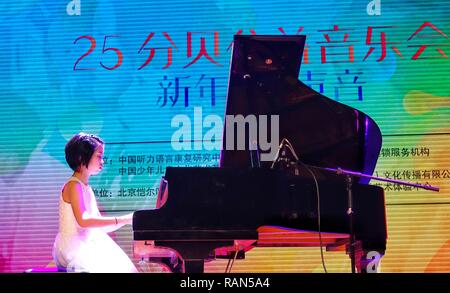 Beijing, China. 4th Jan, 2019. A hearing-impaired child plays the piano during a musical concert in Beijing, capital of China, Jan. 4, 2019. A special concert was held here on Friday to call for more attention to children with hearing impairment. Credit: Li Xin/Xinhua/Alamy Live News Stock Photo